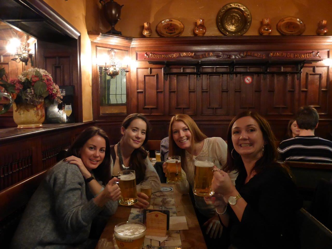 Happy beer drinkers in a cozy back alley bar in Brussels