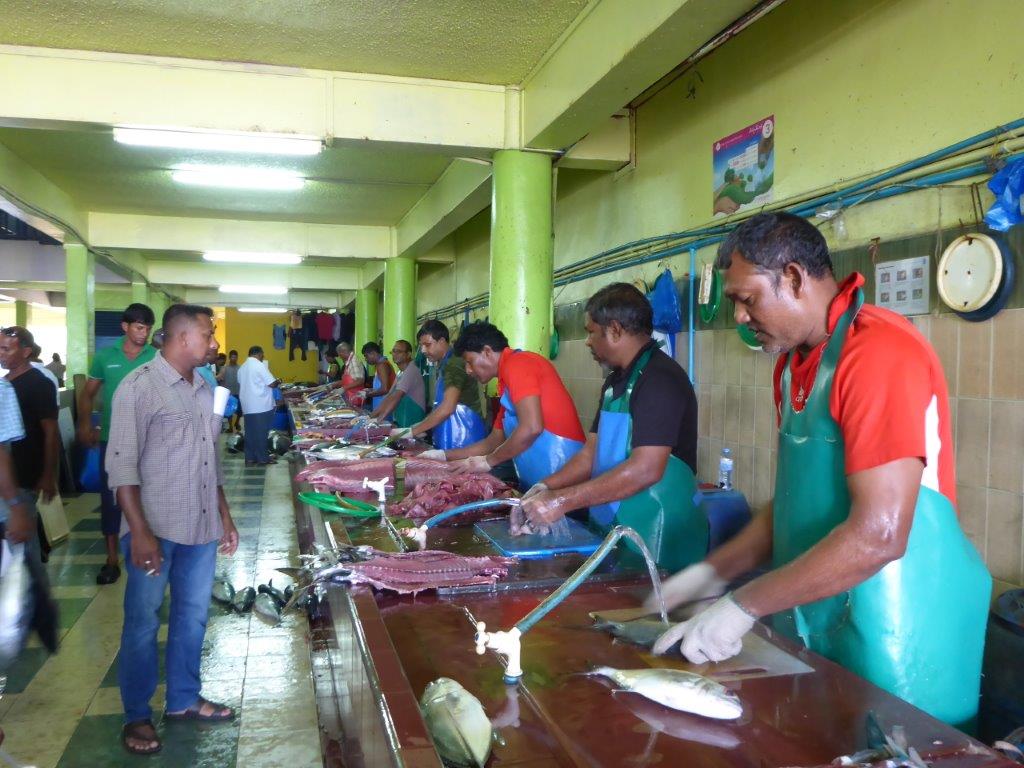 Fishmongers preparing their fish at the fish marked in Male.