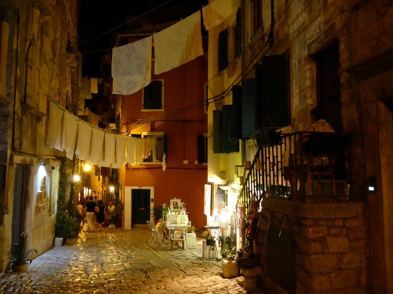 An elderly woman watching over her street in the old town of Rovinj, Croatia