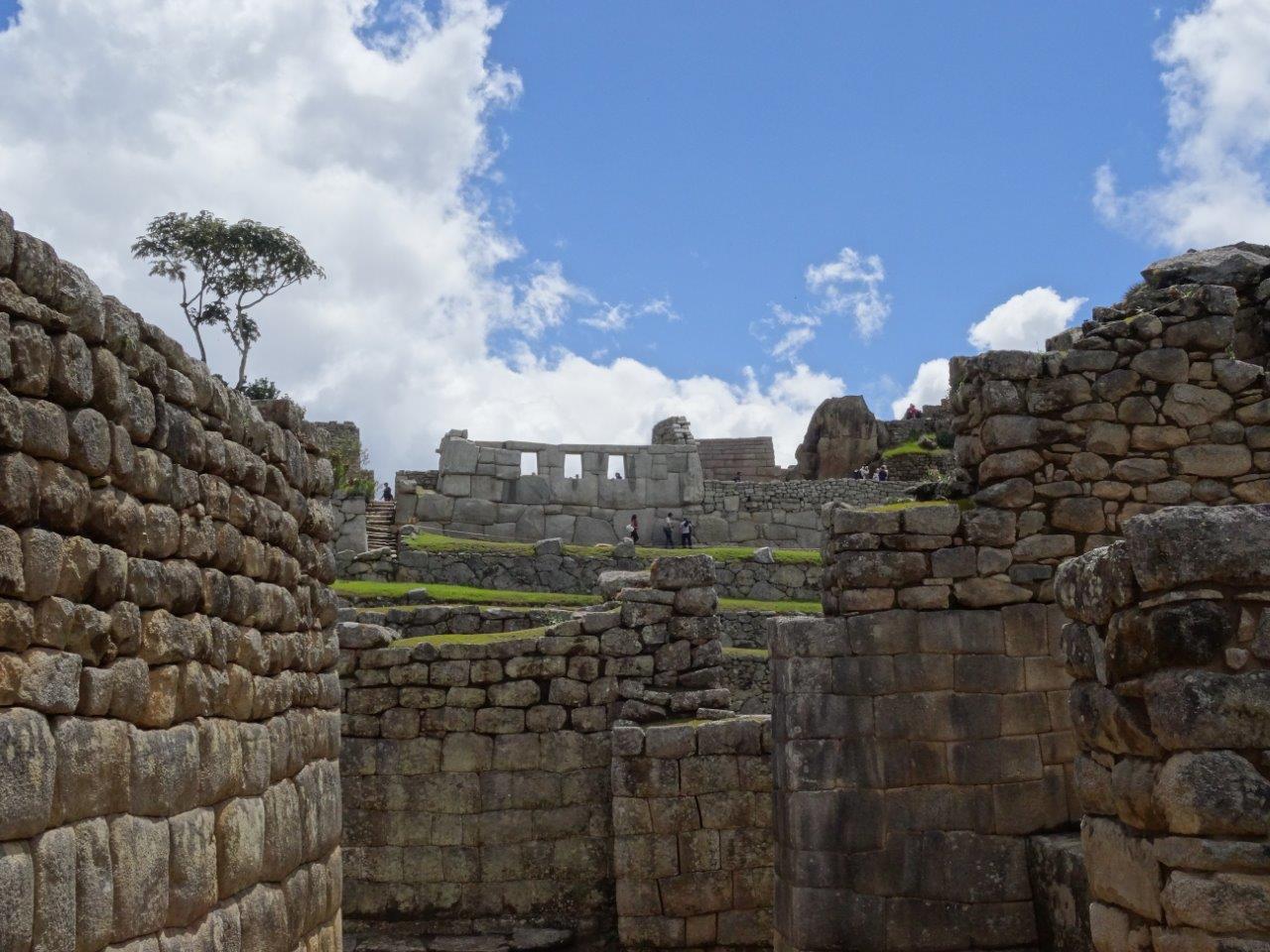 Contrasts. Regular houses and temple at Machu Picchu, Peru