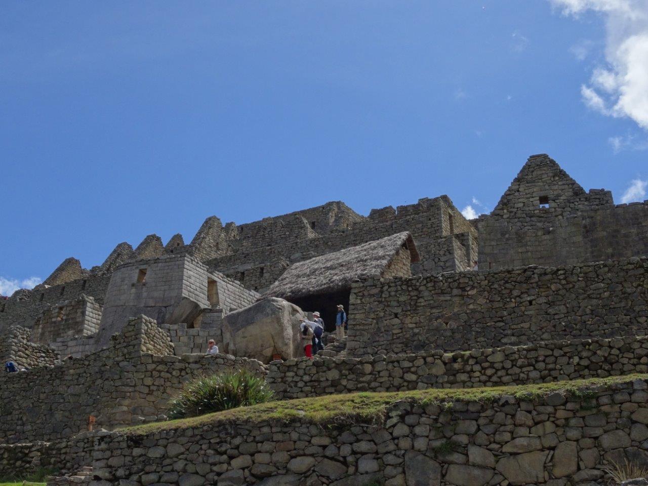 Contrasts. Regular houses and temple at Machu Picchu, Peru