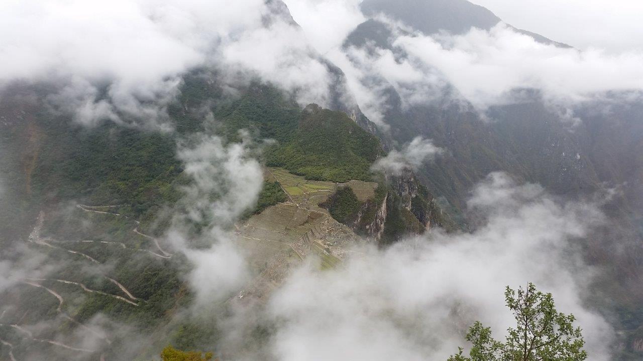 The cloudy carpet revealing Machu Picchu, Peru.