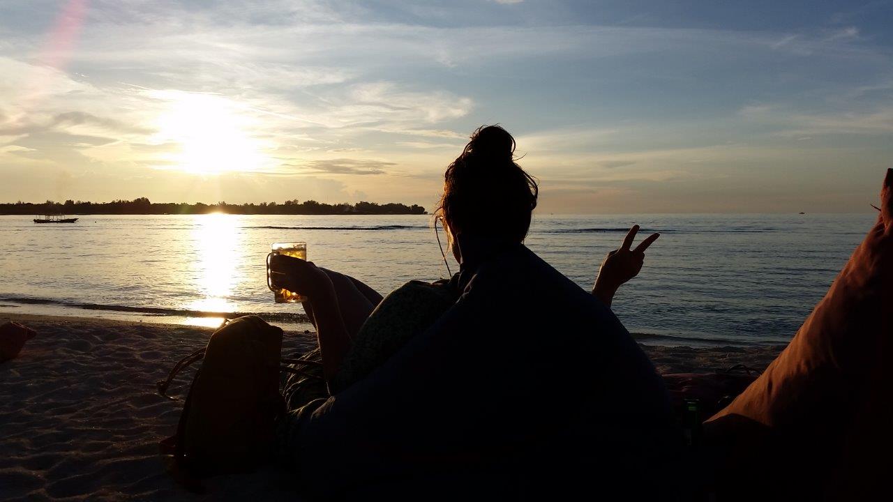 The perfect ending of the day. Sunset and beer at the beach. Gili Meno island, Indonesia