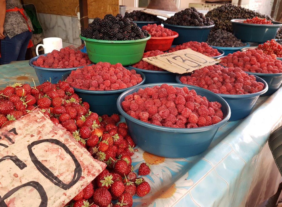 Fresh and tasty berries at Osh Bazaar. Food tour in Bishkek, Kyrgyzstan